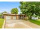 Inviting brick home with an attached two car garage and well-maintained lawn and landscaping at 2876 S Wolff St, Denver, CO 80236