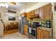 Open-concept kitchen boasting stainless steel appliances and an open view to the dining area at 2876 S Wolff St, Denver, CO 80236