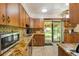 Functional kitchen showcasing granite countertops, modern appliances, and backyard access at 2876 S Wolff St, Denver, CO 80236