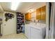 Laundry room with washer, dryer, and storage shelves at 2876 S Wolff St, Denver, CO 80236