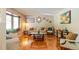 Bright living room featuring hardwood floors, a bay window, and stylish décor at 2876 S Wolff St, Denver, CO 80236