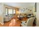 Inviting living room with hardwood floors, a bay window, and comfortable seating at 2876 S Wolff St, Denver, CO 80236