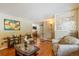 Cozy living room featuring hardwood floors, neutral decor, and an inviting atmosphere at 2876 S Wolff St, Denver, CO 80236