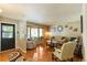 Bright living room with hardwood floors, large windows, and comfortable seating arrangement at 2876 S Wolff St, Denver, CO 80236