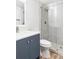 Bathroom features glass enclosed shower, blue vanity with a white granite counter and modern fixtures at 7877 E Mississippi Ave # 901, Denver, CO 80247