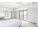 Bright bedroom features sliding glass door to balcony and mirrored closet doors at 7877 E Mississippi Ave # 901, Denver, CO 80247