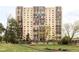An exterior shot shows a tall, modern apartment building with a well-maintained grassy lawn and trees in front at 7877 E Mississippi Ave # 901, Denver, CO 80247