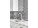 Kitchen sink and light gray subway tile backsplash at 7877 E Mississippi Ave # 901, Denver, CO 80247