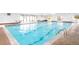 Bright indoor swimming pool with large windows and surrounding seating at 7877 E Mississippi Ave # 901, Denver, CO 80247