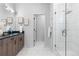 Elegant bathroom with a double vanity, sleek countertops, and a glass-enclosed walk-in shower at 9066 Harlan St, Westminster, CO 80031