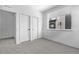 Bright bedroom with plush carpet, double closets, and a large window, perfect for a serene retreat at 9066 Harlan St, Westminster, CO 80031