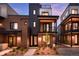 Stunning modern townhome with brick and metal exterior, balcony, and landscaped front yard at dusk at 9066 Harlan St, Westminster, CO 80031