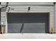 Grey garage door, exterior view at 9066 Harlan St, Westminster, CO 80031