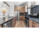 Stylish kitchen boasts wood cabinets, stainless steel appliances, and a functional layout at 9066 Harlan St, Westminster, CO 80031