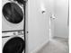 Convenient laundry area with a stacked washer and dryer, maximizing space in the hallway at 9066 Harlan St, Westminster, CO 80031