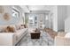Spacious living room filled with light, features a cozy seating arrangement and sliding glass doors to a balcony at 9066 Harlan St, Westminster, CO 80031