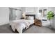 Calm bedroom featuring a plush bed, natural light and an en-suite bathroom with sliding barn door at 9066 Harlan St, Westminster, CO 80031
