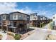 Street view of modern townhomes with attractive landscaping and colorful art installation along the sidewalk at 9066 Harlan St, Westminster, CO 80031