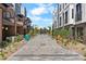 Attractive walkway through modern townhome community with colorful benches and landscaping at 9066 Harlan St, Westminster, CO 80031