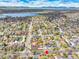 Expansive aerial view of a residential neighborhood with a lake and mountain range in the background on a clear day at 2327 Lowell Blvd, Denver, CO 80211