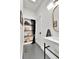Well-organized bathroom with shelves, modern fixtures, and stylish black and white tile floor at 2327 Lowell Blvd, Denver, CO 80211
