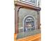 Close-up of the fireplace with an intricately carved mantle and decorative details at 2327 Lowell Blvd, Denver, CO 80211