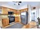Cozy kitchen featuring stainless steel appliances, light wood cabinets and hardwood floors at 2327 Lowell Blvd, Denver, CO 80211