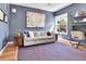 Comfortable living room with blue walls, hardwood floors, and a cozy seating area at 2327 Lowell Blvd, Denver, CO 80211