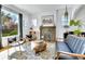 Bright living room featuring a decorative fireplace, hardwood floors, and cozy seating area at 2327 Lowell Blvd, Denver, CO 80211
