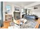 Open-concept living room featuring a fireplace, hardwood floors, and plenty of natural light at 2327 Lowell Blvd, Denver, CO 80211