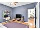 Comfortable living room with desk, TV and hardwood floors at 2327 Lowell Blvd, Denver, CO 80211
