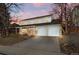 Two-story house with attached two-car garage and front yard landscaping at dusk at 5875 E Weaver Cir, Centennial, CO 80111