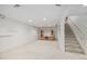 Spacious basement with carpet and stairs to the main level at 5502 E Center Ave, Denver, CO 80246