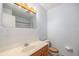 Bathroom featuring a vanity with a sink, toilet, and a large mirror at 5502 E Center Ave, Denver, CO 80246