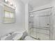 Clean bathroom featuring a glass shower door and a sink with silver fixtures at 5502 E Center Ave, Denver, CO 80246