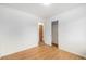 Bedroom featuring hardwood floors, closet, and ensuite bathroom at 5502 E Center Ave, Denver, CO 80246