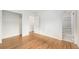 Bright bedroom featuring hardwood floors, closet, and ensuite bathroom at 5502 E Center Ave, Denver, CO 80246