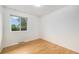 Bedroom with a large window and hardwood floors at 5502 E Center Ave, Denver, CO 80246
