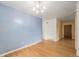 Dining room featuring hardwood floors, a modern light fixture, and a soothing color palette for elegant dining at 5502 E Center Ave, Denver, CO 80246