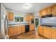 Bright kitchen with wood cabinets, stainless steel appliances, and a functional layout for easy meal preparation at 5502 E Center Ave, Denver, CO 80246