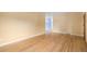 Spacious living room boasts beautiful hardwood floors, neutral wall color, and ample natural light at 5502 E Center Ave, Denver, CO 80246