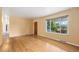 Bright living room featuring hardwood floors, a large window, and fresh paint, creating a welcoming space at 5502 E Center Ave, Denver, CO 80246
