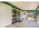 Spacious patio with a brick wall, concrete floor, and sliding glass door to indoors at 5502 E Center Ave, Denver, CO 80246