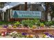 Southglenn Commons community sign, set among colorful flowers and lush greenery at 7275 S Gaylord St # I09, Littleton, CO 80122
