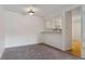 Dining room with neutral carpet and open view to the kitchen for easy access at 7275 S Gaylord St # I09, Littleton, CO 80122