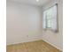 Bright, empty room features neutral walls, tile flooring, and a window letting in natural light at 7275 S Gaylord St # I09, Littleton, CO 80122