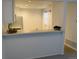 Bright kitchen features a breakfast bar, white cabinets, and great natural light at 7275 S Gaylord St # I09, Littleton, CO 80122
