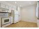 Efficient kitchen with white appliances and ample counter space, plus a storage closet at 7275 S Gaylord St # I09, Littleton, CO 80122