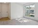 Bright living room with carpet, large window, and a view of the community at 7275 S Gaylord St # I09, Littleton, CO 80122