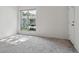 Inviting living room featuring a large window and neutral carpet, flooded with natural light at 7275 S Gaylord St # I09, Littleton, CO 80122